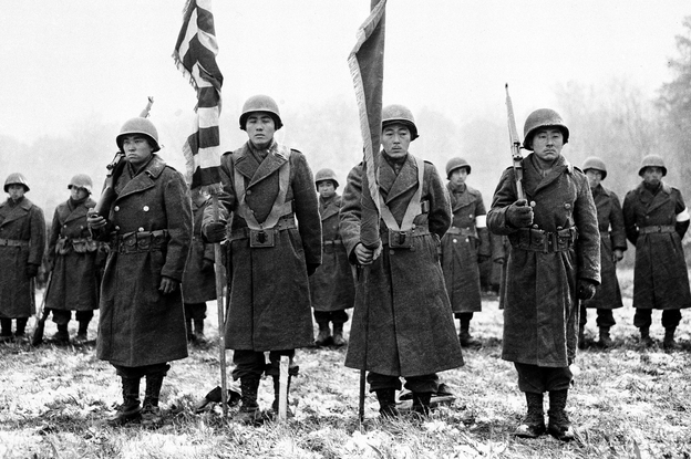 Members of the Japanese-American 442nd Combat Team stand at attention on Nov. 12, 1944. The National WWII Museum in New Orleans asks visitors to consider the dilemma Japanese-Americans faced when they were asked to enlist.
