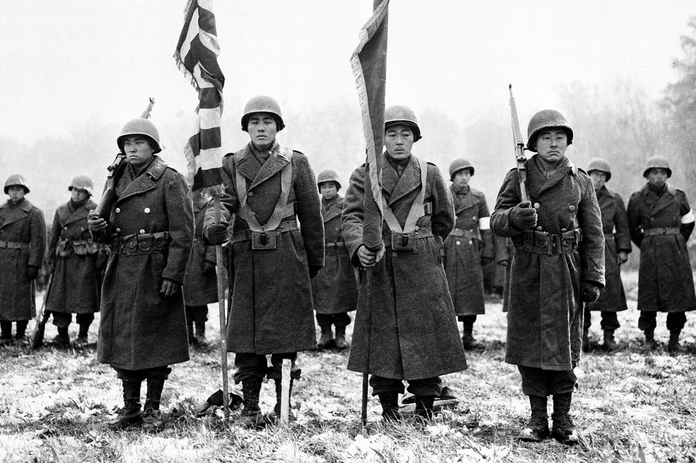 Members of the Japanese-American 442nd Combat Team stand at attention on Nov. 12, 1944. The National WWII Museum in New Orleans asks visitors to consider the dilemma Japanese-Americans faced when they were asked to enlist.