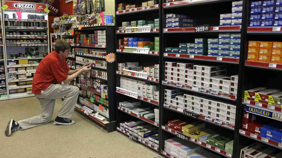 A clerk prices cigarettes at  Discount Smoke Shop in Ballwin, Mo. The Food and Drug Administration, which must approve all new tobacco products or any changes to existing brands, has not cleared any products since assuming that responsibility in 2009.
