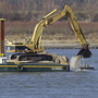 An excavator perched on a barge removes rocks from the Mississippi River in Thebes Ill. An excavator perched on a barge removes rocks from the Mississippi River in Thebes Ill.