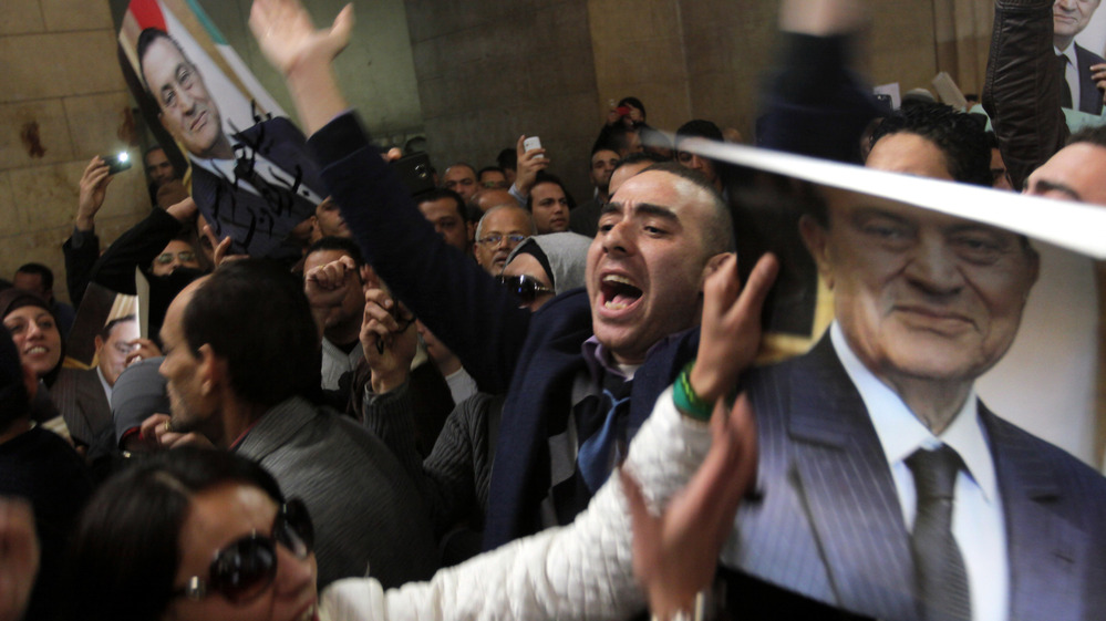 Egyptians supporters of ousted former President Hosni Mubarak celebrate an appeal granted by a court, in Cairo, Egypt, Sunday.