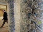 A student walks past a sculpture made of empty water bottles on the University of Vermont campus. UVM has banned the sale of bottled water. A student walks past a sculpture made of empty water bottles on the University of Vermont campus. UVM has banned the sale of bottled water.