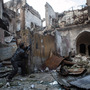 A rebel fighter fires toward Syrian government forces in the Bab al-Nasr district of Aleppo's Old City, earlier this month. The city has been a major battleground for the past six months.