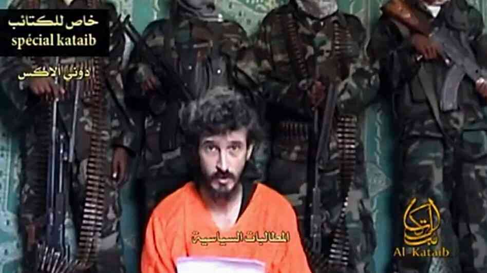 An undated screen image of footage shot by Al-Kataib Media, showing Denis Allex, a French hostage allegedly held by Somali militants, who was reportedly killed during the  failed rescue mission.