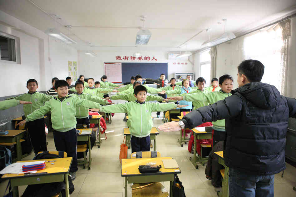 Students take an indoor physical education class at Shoushuihe Elementary School in Beijing, as outdoor sports activities for primary and middle schools were halted due to heavy air pollution. Heavy smog has caused highway closures and flight delays in several provinces.