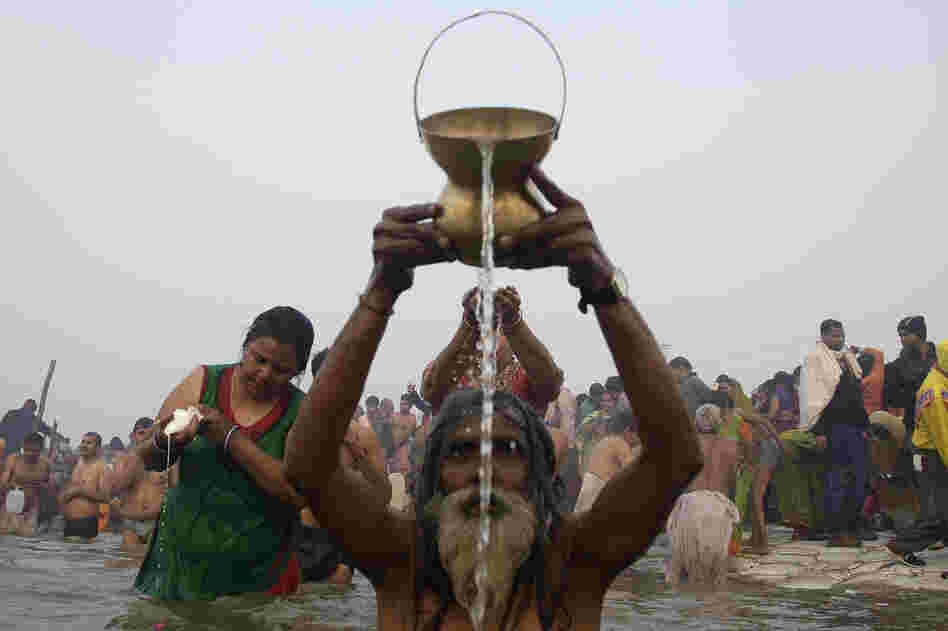 Devotees pray and wash as they attend the first Shahi Snan, or grand bath. Up to 100 million worshippers will gather at the Kumbh Mela over the next 55 days to take a ritual bath in the holy waters, believed to cleanse sins and bestow blessings.