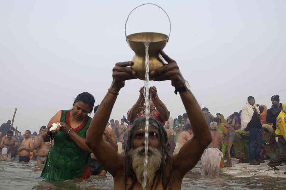 Devotees pray and wash as they attend the first Shahi Snan, or grand bath. Up to 100 million worshippers will gather at the Kumbh Mela over the next 55 days to take a ritual bath in the holy waters, believed to cleanse sins and bestow blessings.