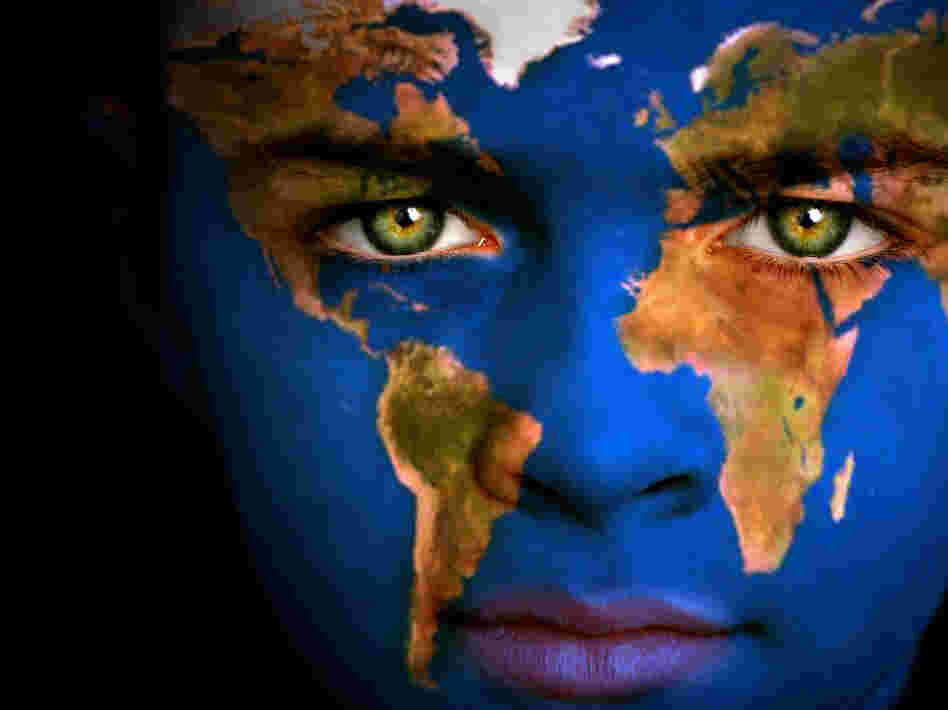 Portrait of a boy with the map of the world painted on his face.