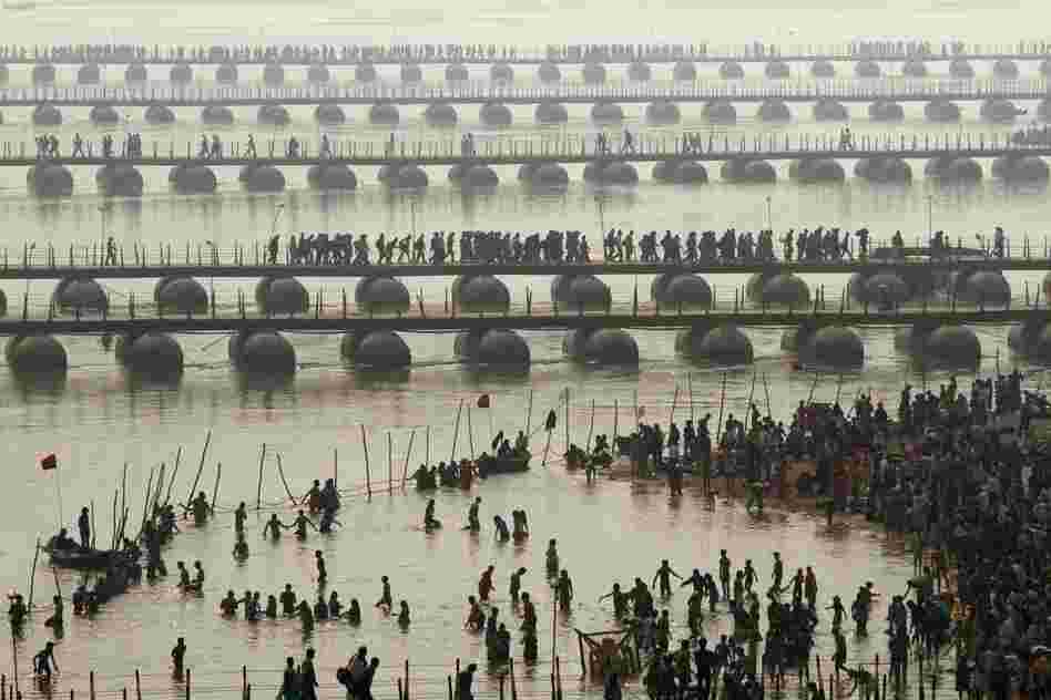 Hundreds of thousands of Hindu pilgrims led by naked, ash-covered holy men stream into the sacred waters Monday at the start of the world's biggest religious festival.