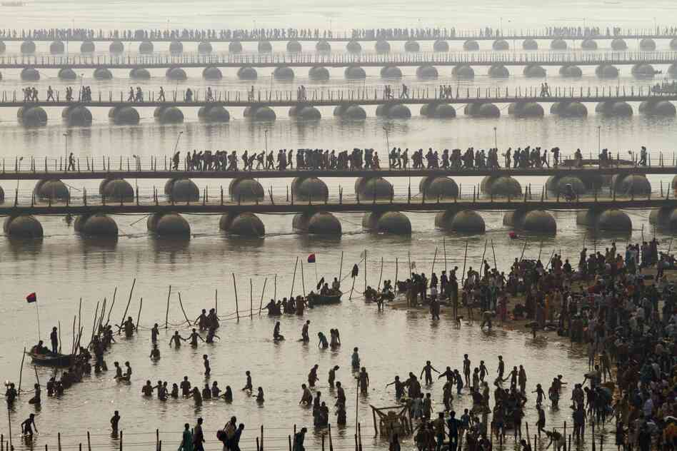 Hundreds of thousands of Hindu pilgrims led by naked, ash-covered holy men stream into the sacred waters Monday at the start of the world's biggest religious festival.