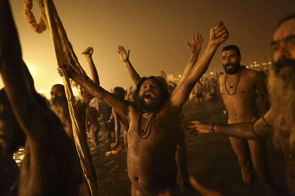 Naga Sadhus celebrate naked in the water at Sangam.