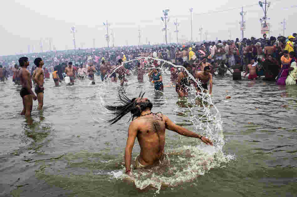 A Hindu holy man, or Naga Sadhu, swings his hair during the royal bath on Makar Sankranti.