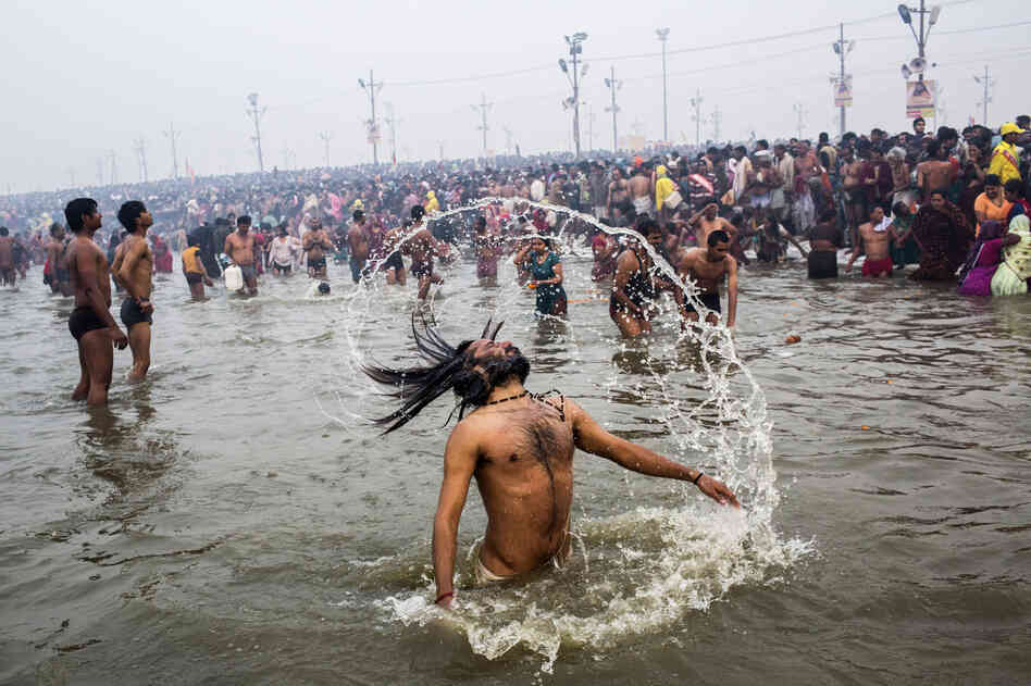 A Hindu holy man, or Naga Sadhu, swings his hair during the royal bath on Makar Sankranti.