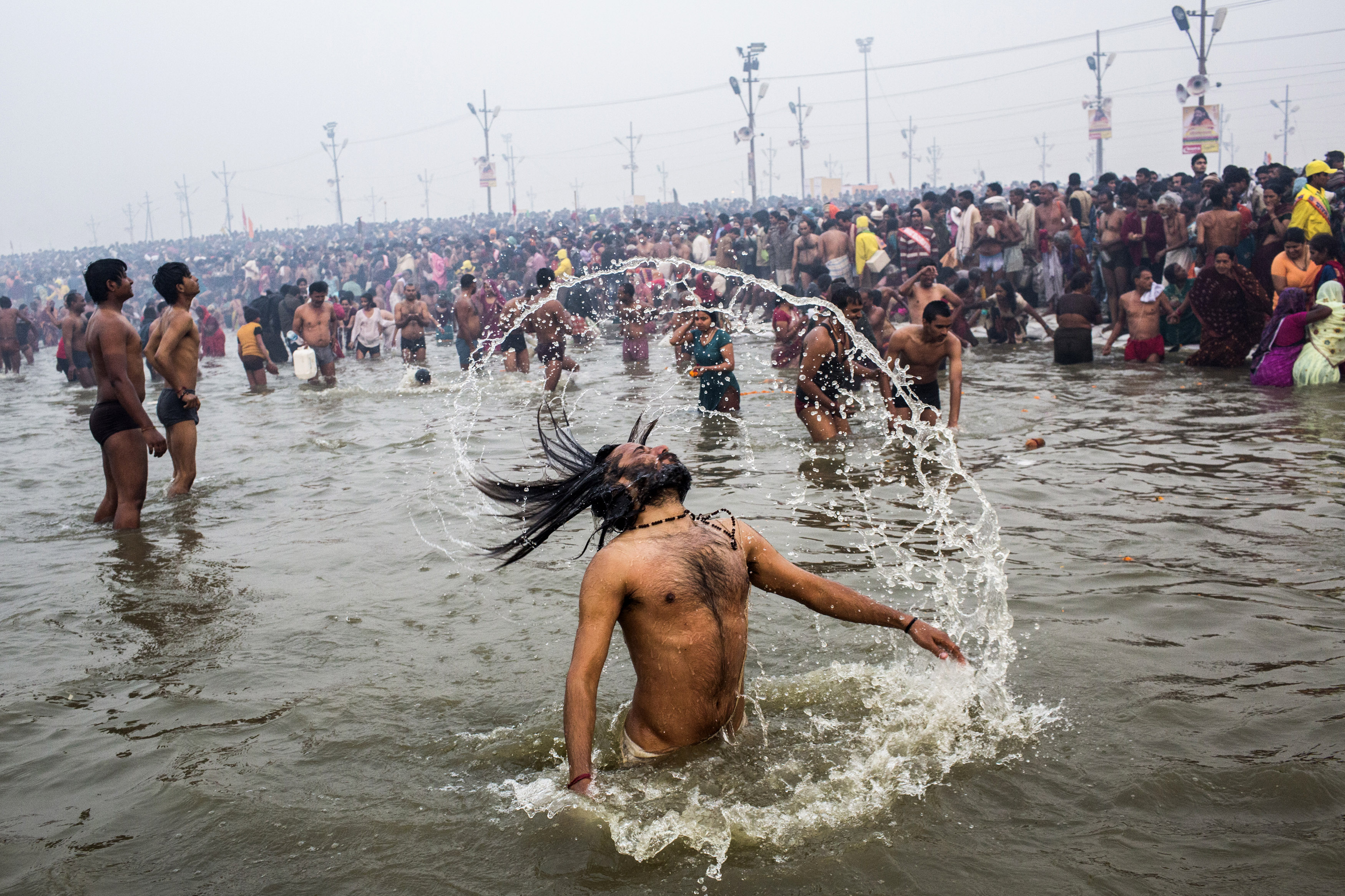 A Hindu holy man, or Naga Sadhu, swings his hair during the royal bath on Makar Sankranti.