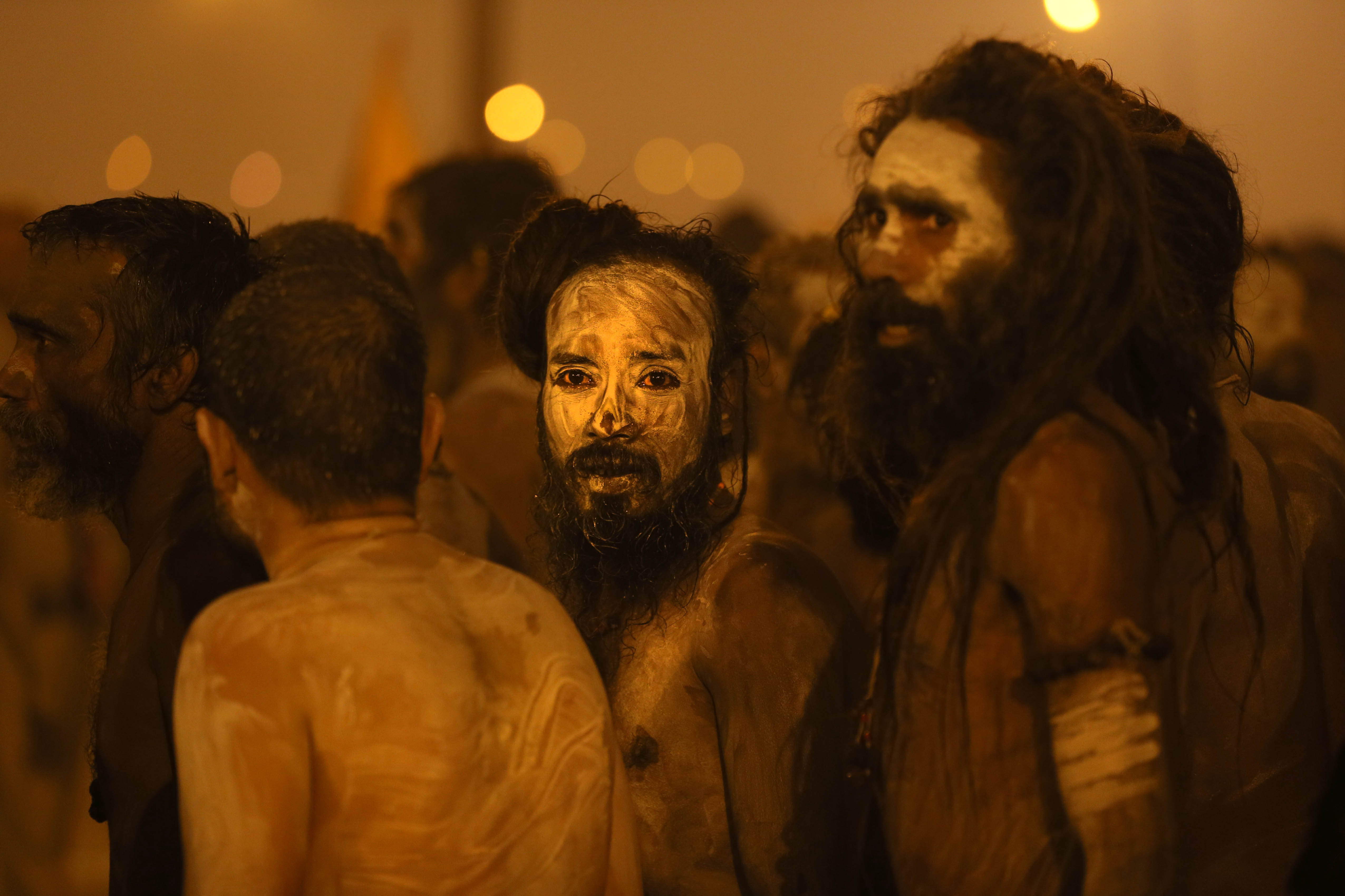 Naga Sadhus return after a dip in the holy waters.