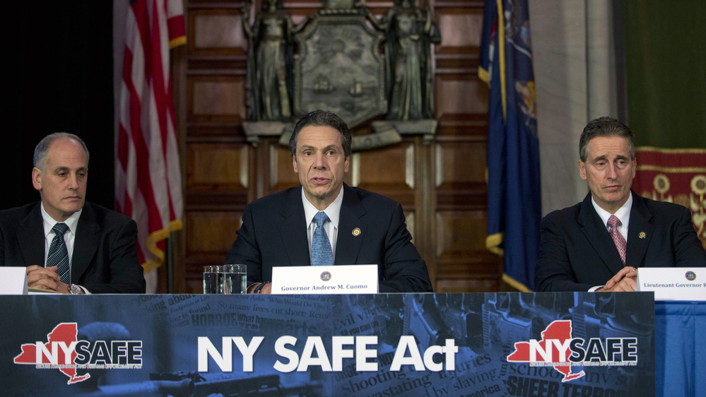 New York Gov. Andrew Cuomo announces an agreement with legislative leaders Monday on a measure that would make New York the first state to pass tough new gun laws after the Newtown, Conn., shootings. With Cuomo are secretary to the governor Larry Schwartz (left) and Lt. Gov. Robert Duffy. New York Gov. Andrew Cuomo announces an agreement with legislative leaders Monday on a measure that would make New York the first state to pass tough new gun laws after the Newtown, Conn., shootings. With Cuomo are secretary to the governor Larry Schwartz (left) and Lt. Gov. Robert Duffy.