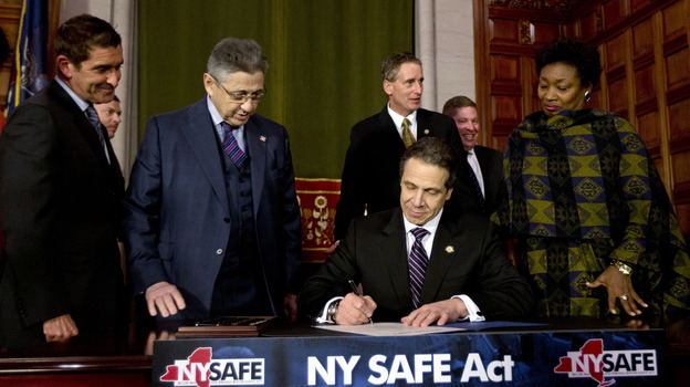 New York Gov. Andrew Cuomo signs New York's new gun-control law Tuesday in Albany, N.Y. (AP)