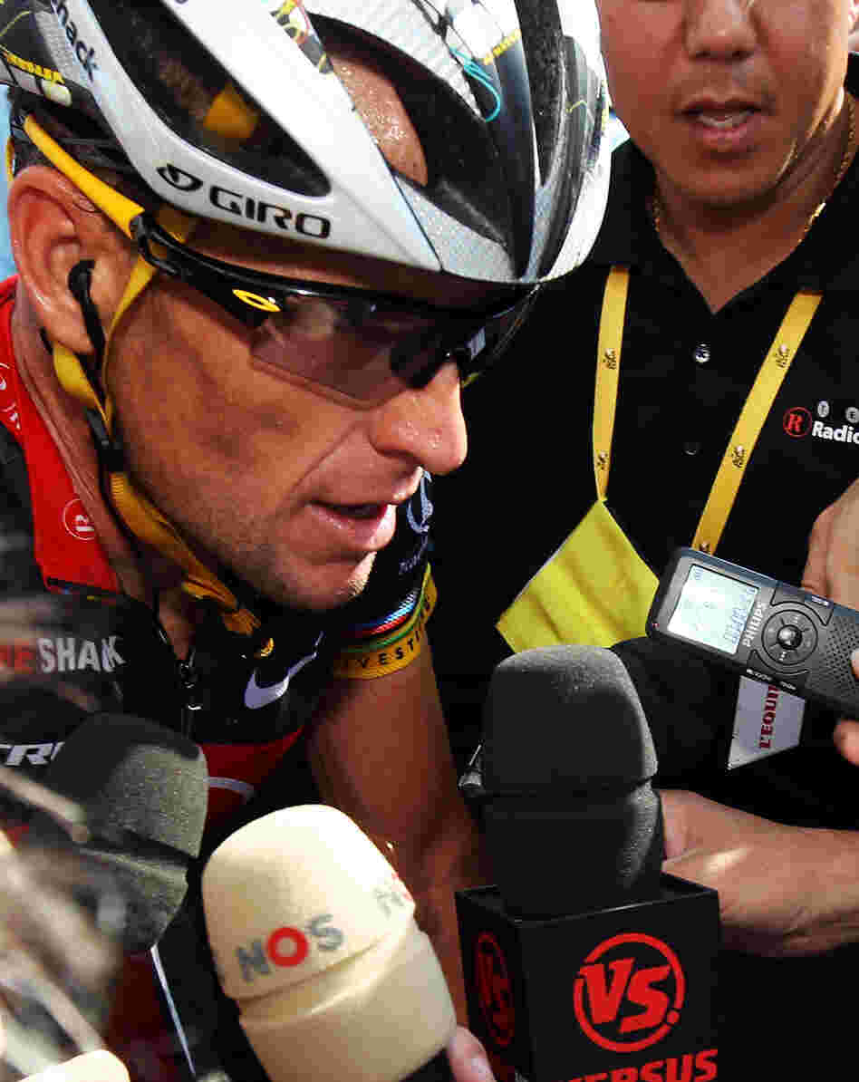 Armstrong talks to the press at the finish line of stage eight of the 2010 Tour de France.