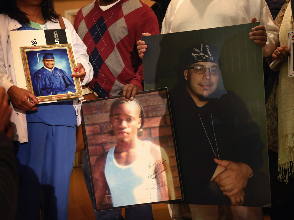 Community leaders and family members of murder victims attend a press conference Jan. 3 at St. Sabina Church in Chicago to make a plea for stronger gun regulations.