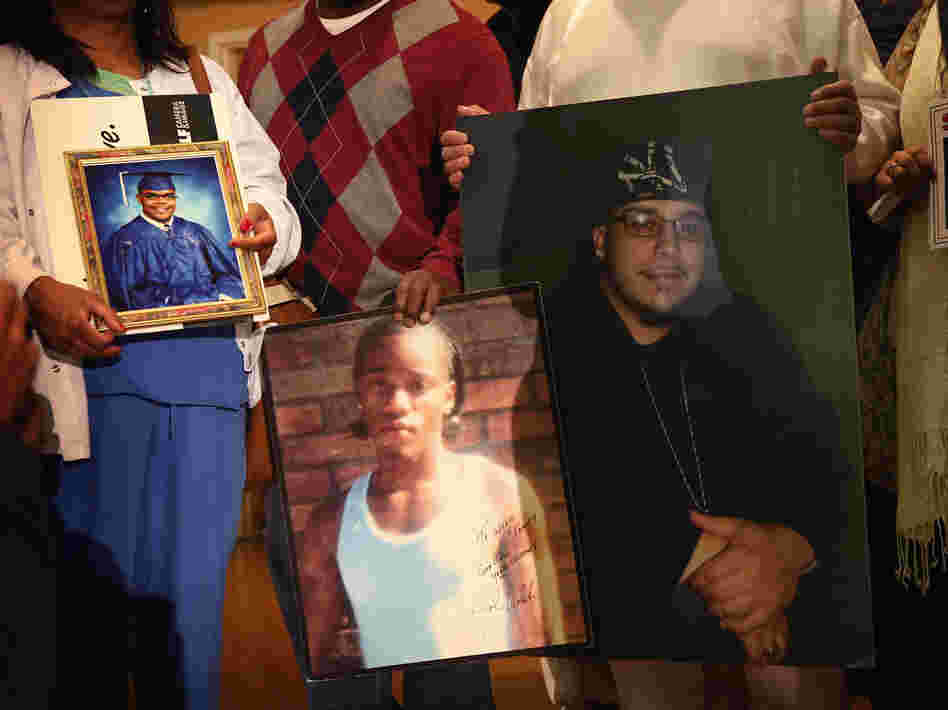 Community leaders and family members of murder victims attend a press conference Jan. 3 at St. Sabina Church in Chicago to make a plea for stronger gun regulations.