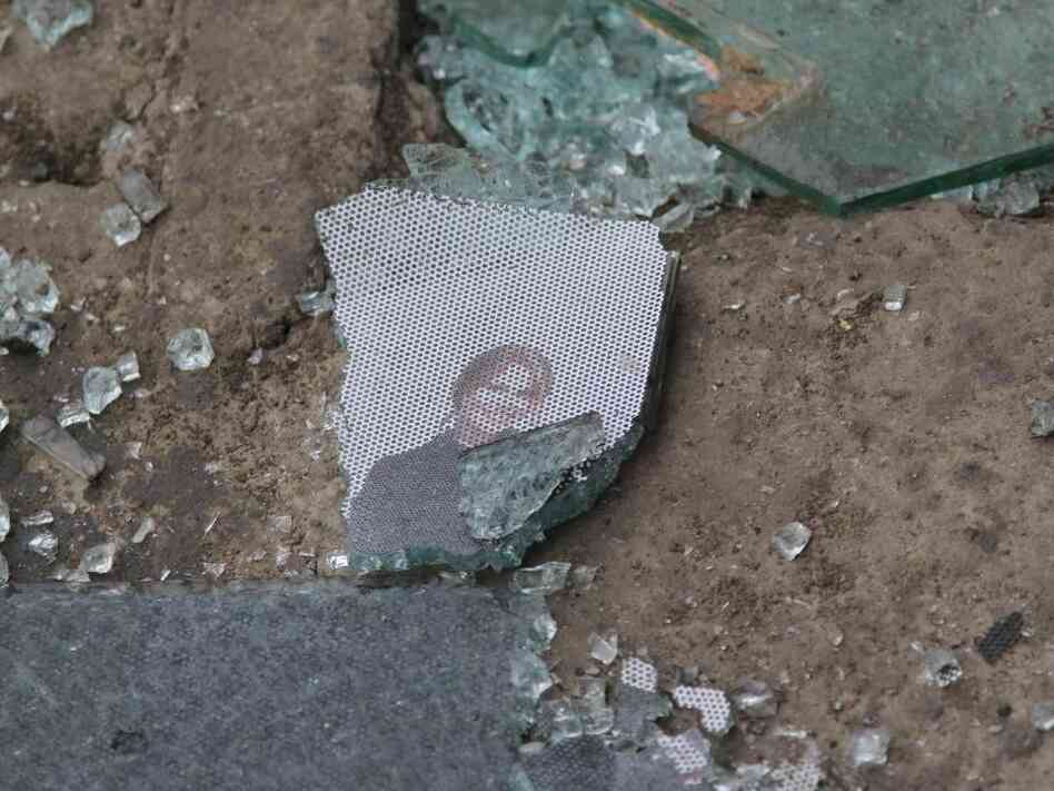 Glass, and remnants of a picture, on the street at the scene of the bombing in Kabul.