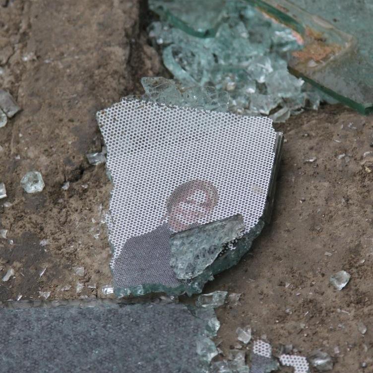 Glass, and remnants of a picture, on the street at the scene of the bombing in Kabul.
