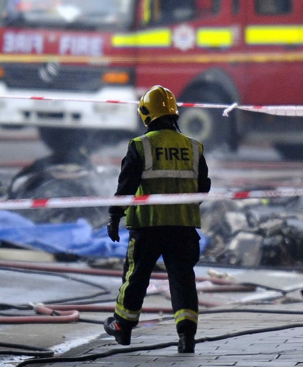 A firefighter walks toward some of the wreckage at the scene of today's helicopter crash in London. A firefighter walks toward some of the wreckage at the scene of today's helicopter crash in London.