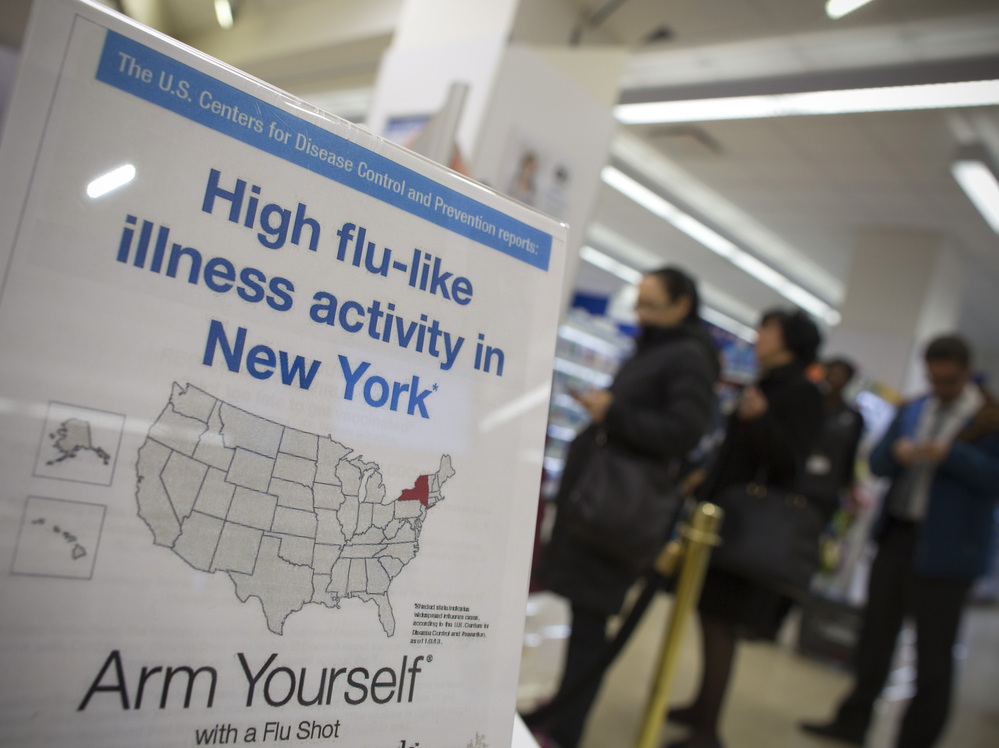 People line up at a Duane Reade pharmacy in New York behind a sign announcing the recent flu outbreak. People line up at a Duane Reade pharmacy in New York behind a sign announcing the recent flu outbreak.
