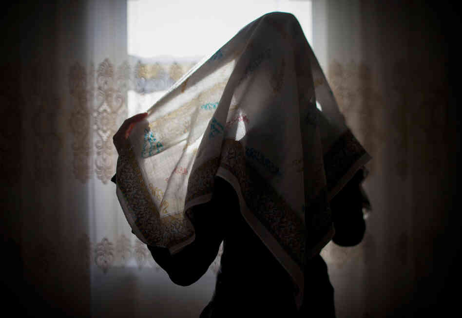 Seda Makhagieva, 15, wraps a pastel-colored head and neck covering. Makhagieva fought to wear the hijab — a sharp break from her family's traditions.