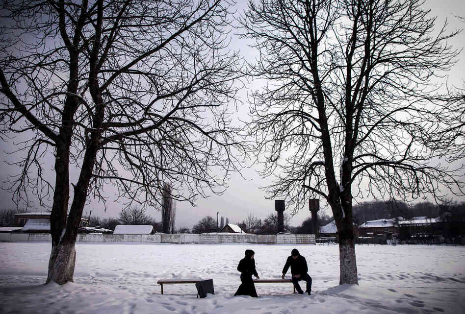 A couple on a date in Serzhen-Yurt. Couples must meet in public and sit at a distance from one another. All physical contact is forbidden before marriage.