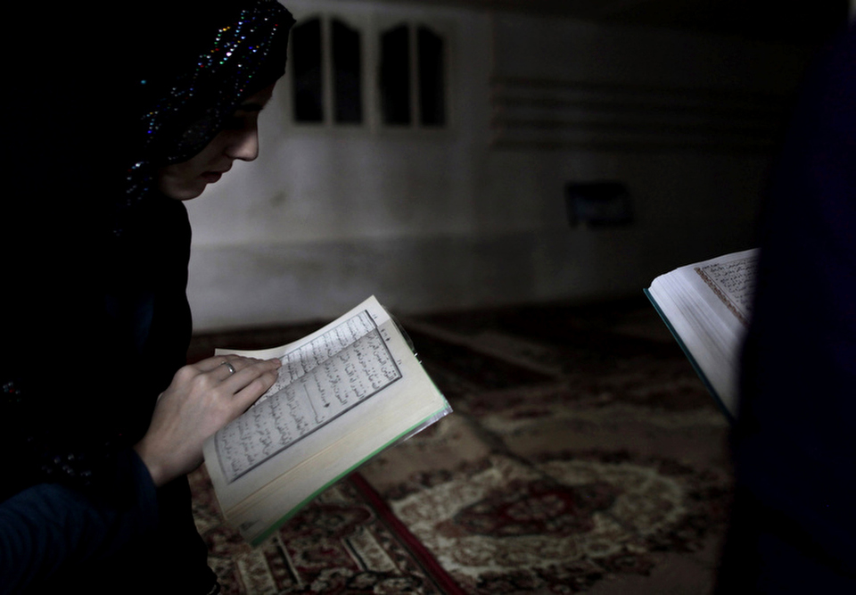 Chechen girls study the Quran at an underground madrassa in the Chechen village of Serzhen-Yurt. The new generation of youth are embracing Islam after decades of religious repression by secular Communist authorities in the Soviet Union.