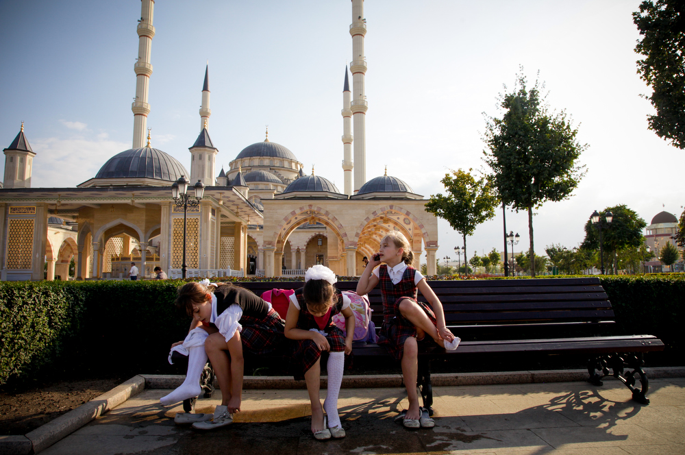 Chechen girls after school in front of the Heart of Chechnya mosque, the largest in Europe. All Chechen girls, despite their religion, must wear a head covering in public schools and government buildings.