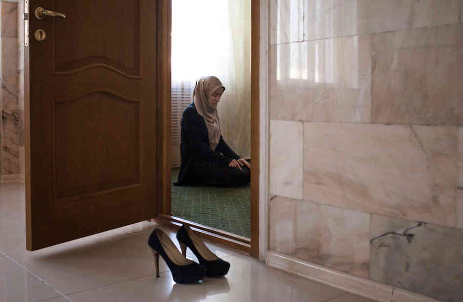 Amina Mutieva, 21, prays before her class at the Islamic University in Grozny.