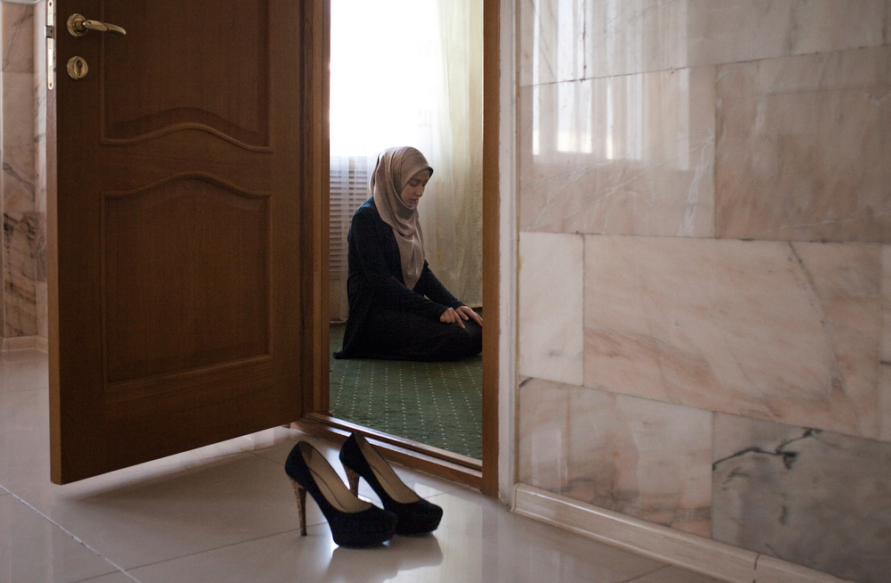 Amina Mutieva, 21, prays before her class at the Islamic University in Grozny.
