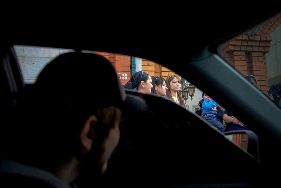A Chechen boy checks out a girl from his black tinted window. Despite official measures, bride kidnapping continues to be an endemic problem: Young women in Chechnya are kidnapped off the street and married to men they may never have met.