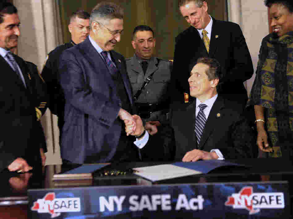 State Senator Jeff Klein (L-R), Assembly Speaker Sheldon Silver, Lieutenant Governor Robert Duffy and Senator Andrea Stewart-Cousins congratulate New York Governor Andrew Cuomo after he signed the New York Secure Ammunition and Firearms Enforcement Act on Tuesday.