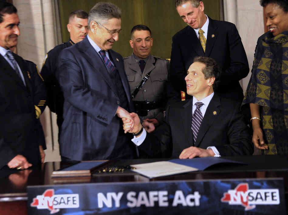 State Senator Jeff Klein (L-R), Assembly Speaker Sheldon Silver, Lieutenant Governor Robert Duffy and Senator Andrea Stewart-Cousins congratulate New York Governor Andrew Cuomo after he signed the New York Secure Ammunition and Firearms Enforcement Act on Tuesday.