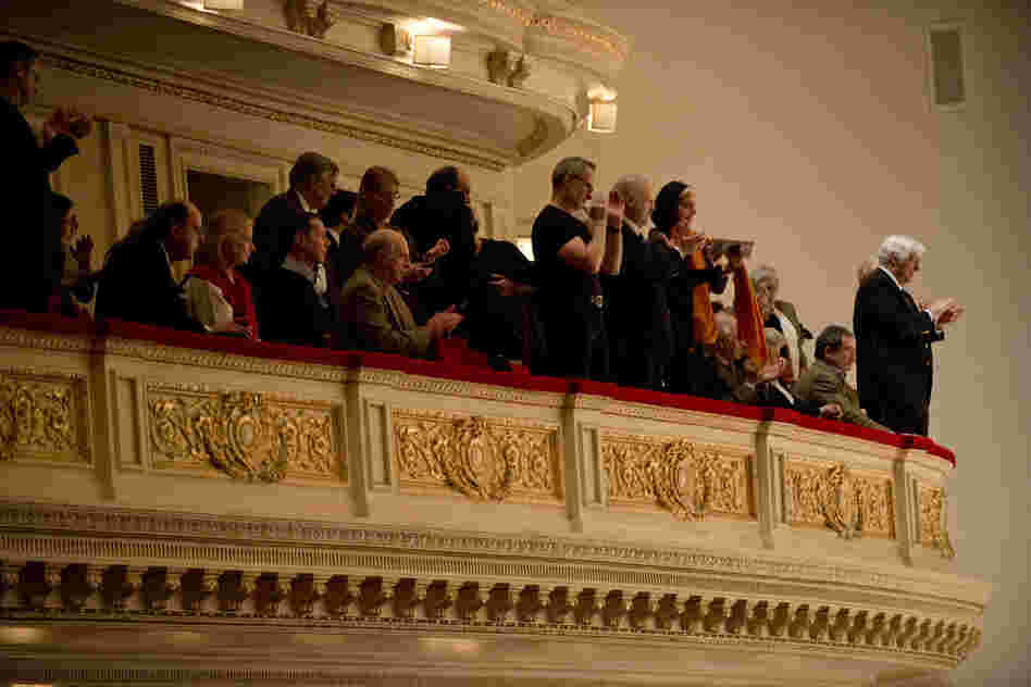 In the balcony at Carnegie Hall, audience members give violinist Leonidas Kavakos and the Philadelphia Orchestra a standing ovation for their performance of the Violin Concerto No. 2 by Karol Szymanowski. 