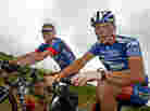 Lance Armstrong, right, faces several court cases tied to evidence that he cheated. One of the suits was filed by his former U.S. Postal Service teammate Floyd Landis. Here, the pair ride during the 2003 Tour de France.
