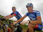 Lance Armstrong, right, faces several court cases tied to evidence that he cheated. One of the suits was filed by his former U.S. Postal Service teammate Floyd Landis. Here, the pair ride during the 2003 Tour de France.