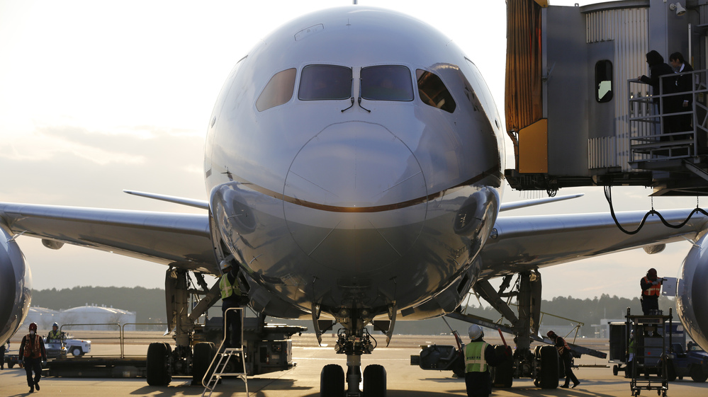 In Tokyo today, a United  Airlines 787 Dreamliner sat at a gate.