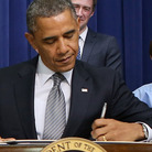 President Obama signs a series of executive orders Wednesday about the administration's gun law proposals as Vice President Biden and children who wrote letters to the White House about gun violence look on.