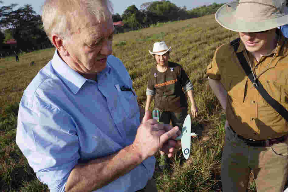 British farmer and businessman David Cundall (left) leads an archaeological excavation team searching for buried World War II Spitfires at an airport in Yangon, Myanmar, Jan. 7. He holds a miniature model of the fighter plane and is accompanied by Tracy Spaight, director of special projects at video game company Wargaming.net, who is funding the effort.
