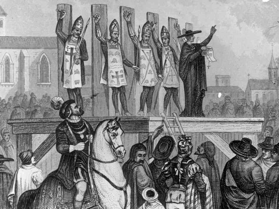 An illustration shows heretics being tortured and nailed to wooden posts during the first Inquisition.