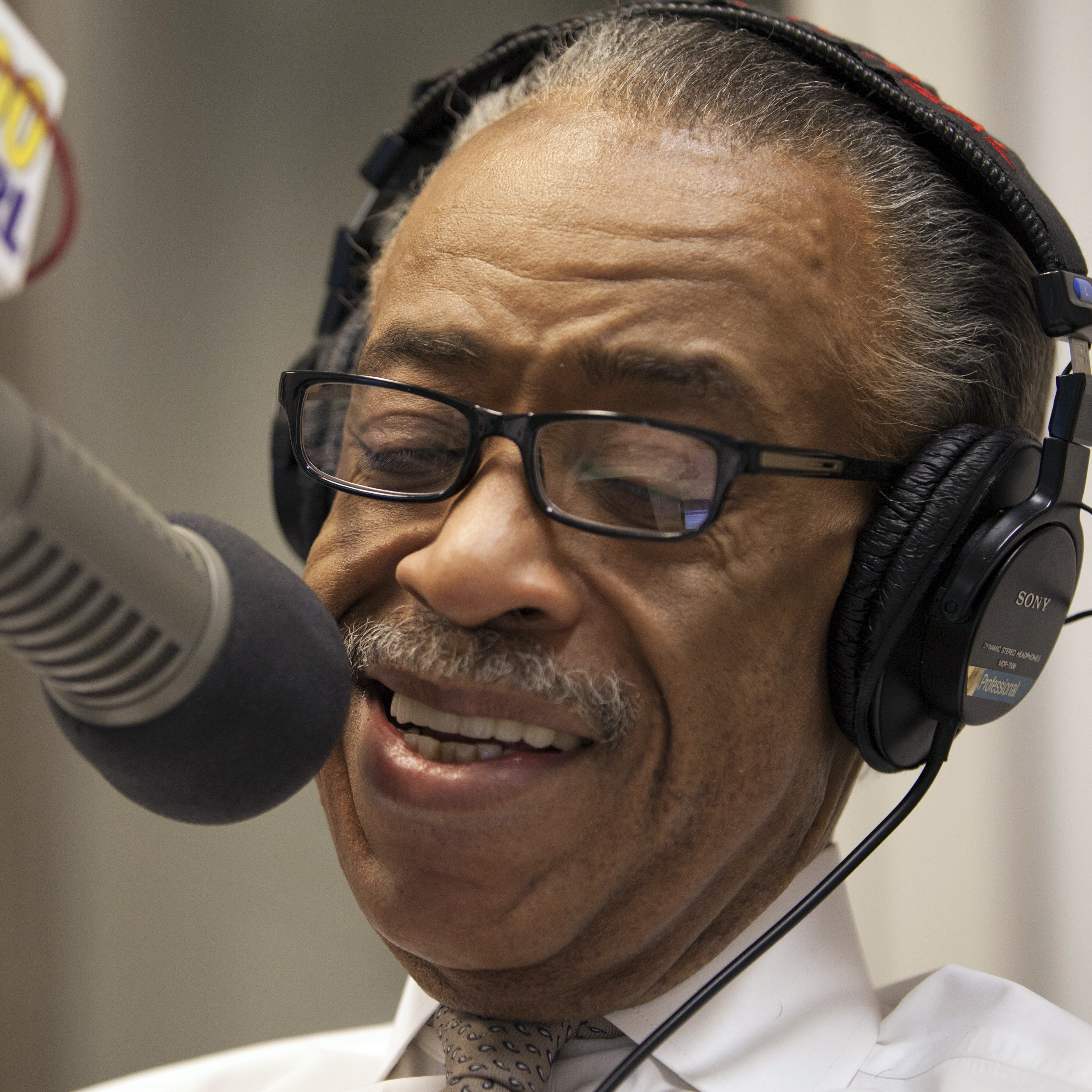 Rev. Al Sharpton smiles during his radio show "Keeping It Real with Reverend Al Sharpton" in New York.