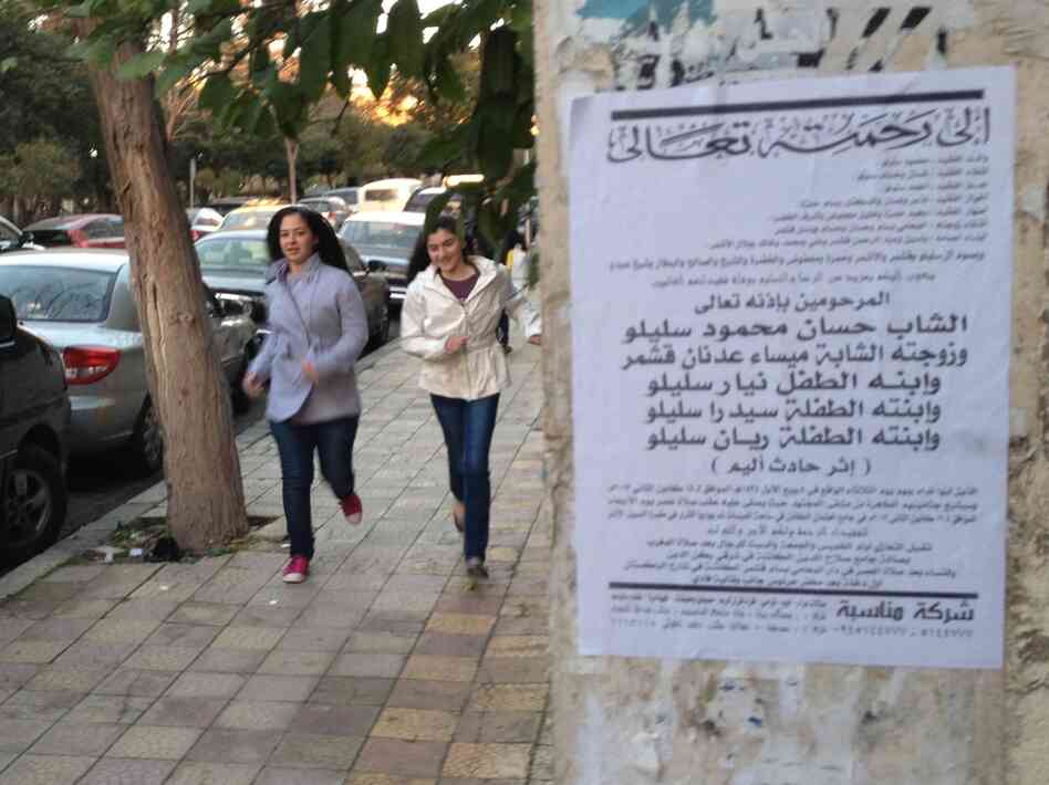 Death notices, like the one on the right, are becoming more common on the streets of Damascus.