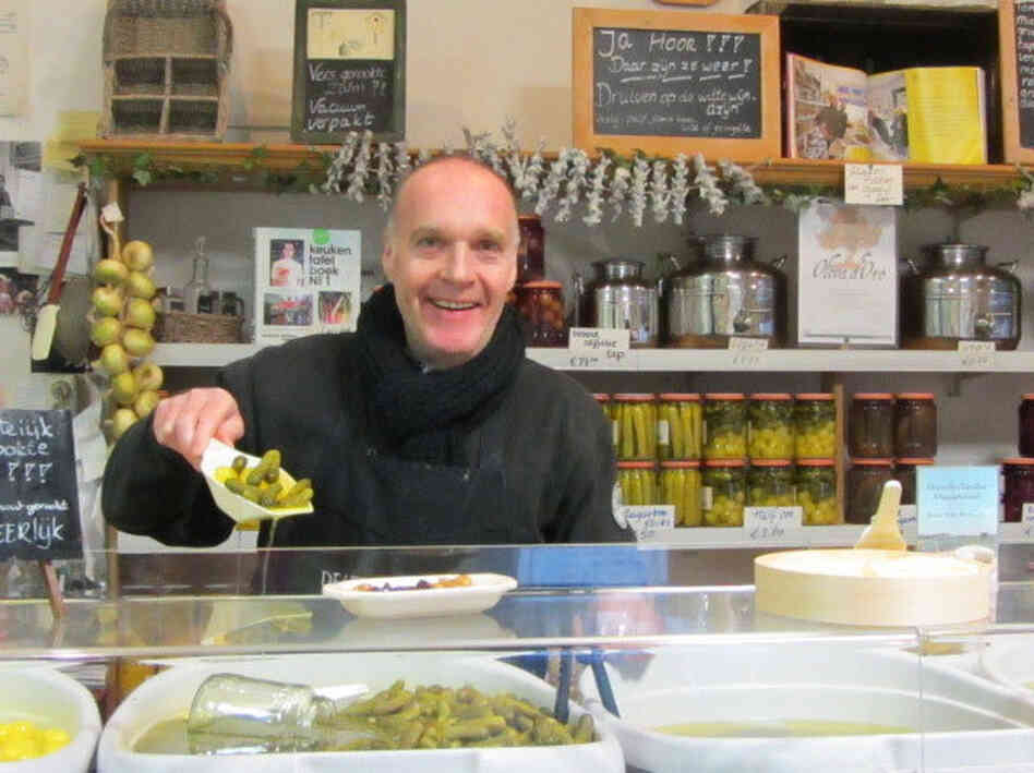 Fred Ooms of De Leeuw Zuurwaren, Amsterdam, modeling the traditional method of measuring de Leeuw pickles, the scoop.
