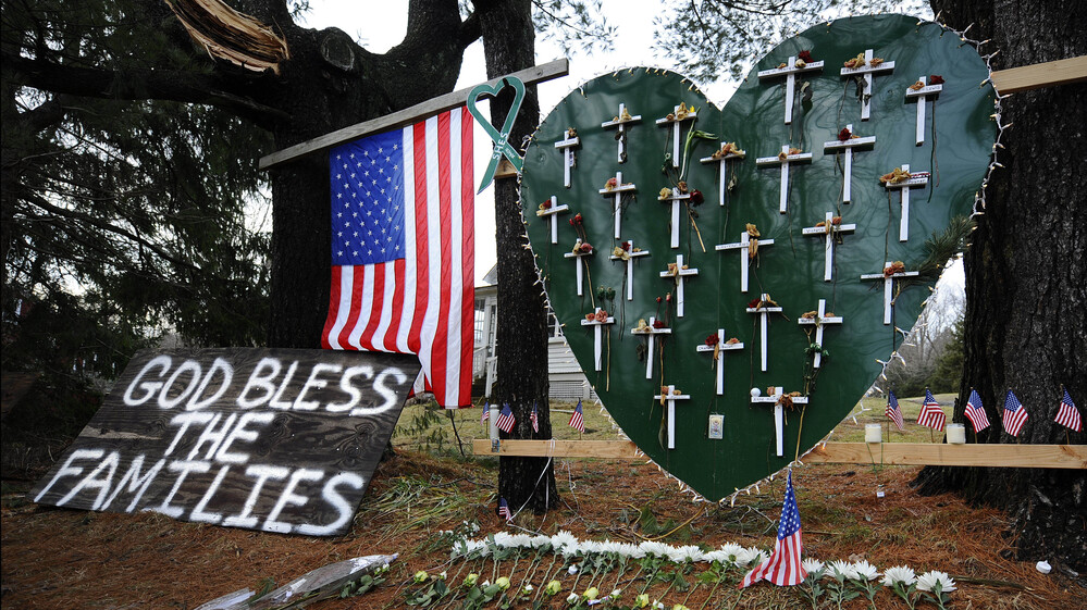 A memorial stands in a yard near the Sandy Hook Elementary School a month after the mass shooting that left 27 dead, including 20 children, in Newtown, Conn.