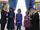President Obama is officially sworn in Sunday by Chief Justice John Roberts in the Blue Room of the White House. Next to Obama are first lady Michelle Obama, holding the Robinson Family Bible, and their daughters, Malia and Sasha.