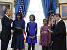 President Obama is officially sworn in Sunday by Chief Justice John Roberts in the Blue Room of the White House. Next to Obama are first lady Michelle Obama, holding the Robinson Family Bible, and their daughters, Malia and Sasha.